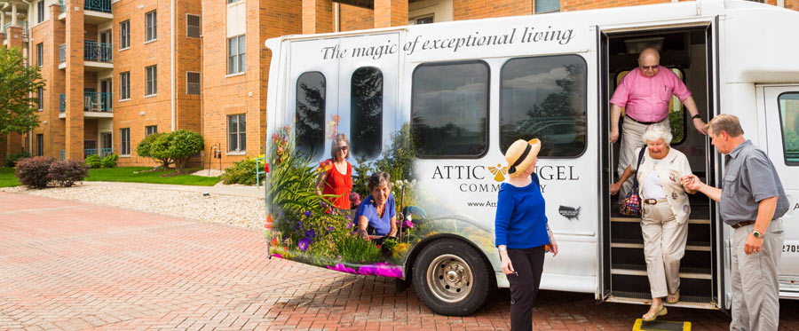 Attic Angel Community in Middleton WI and Madison WI bus with vehicle wrap and elderly people getting off