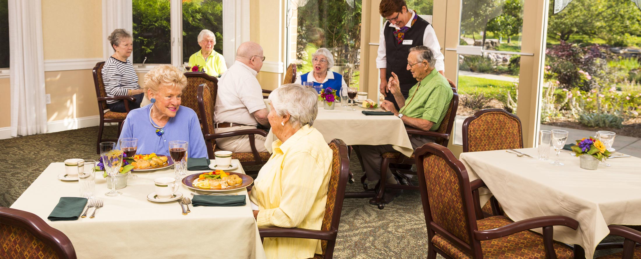 elderly men and women dining at Attic Angel Community